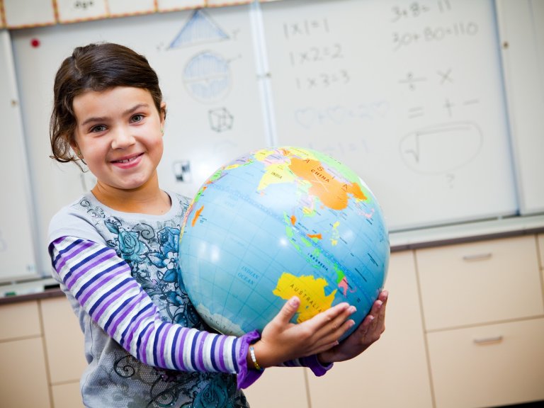 Student holding a globe