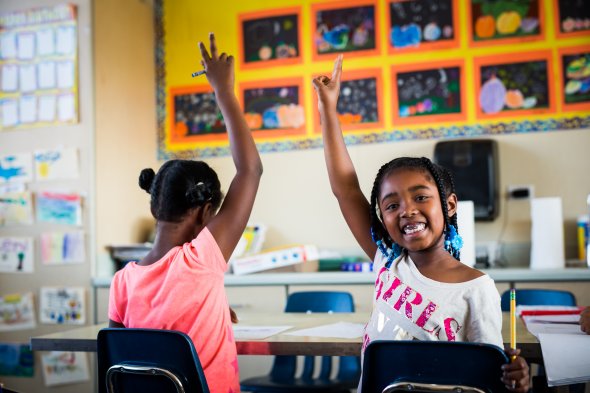 Two students raising their hands