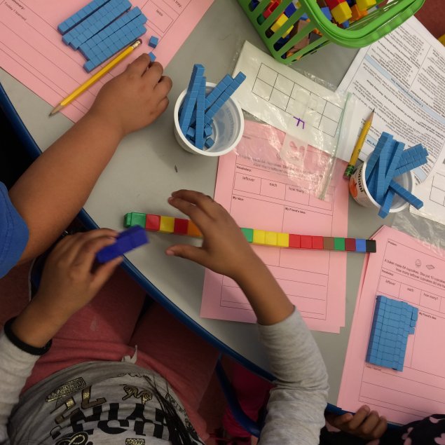 Students using cubes and base-10 blocks to model subtraction