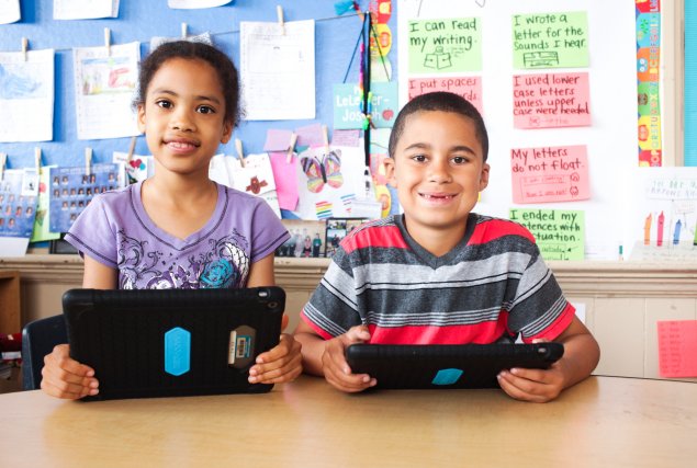 Two students holding iPads
