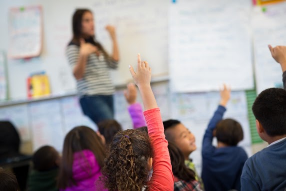 Rasied hands in a classroom