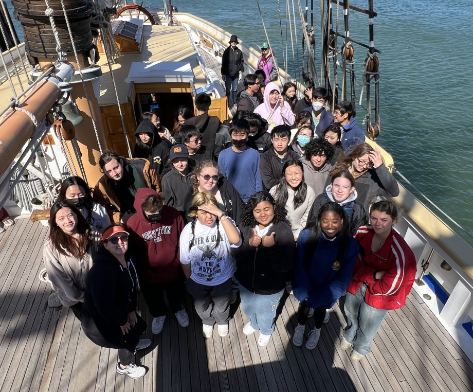 Green Academy students pose for a picture on a sailboat.