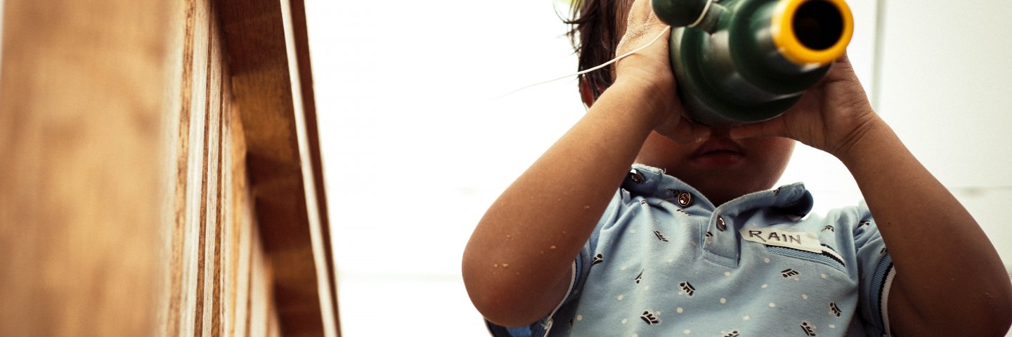 Child looking through spy glass