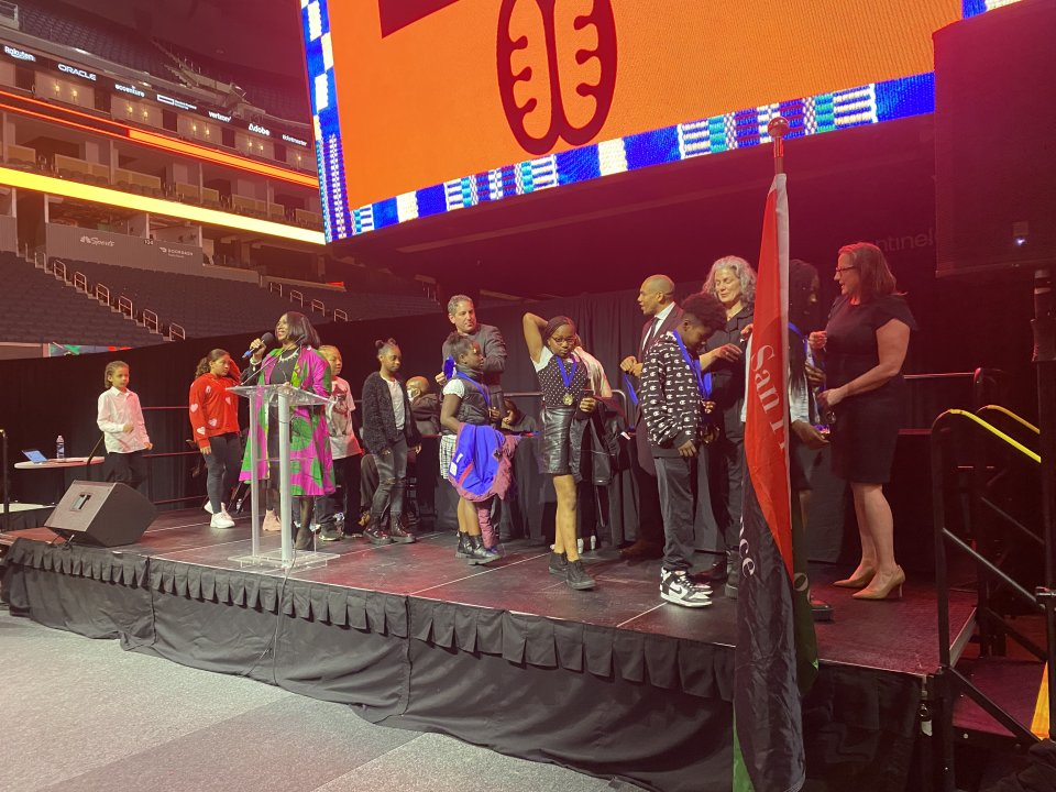 Students receiving african american honor roll on stage at Chase Center