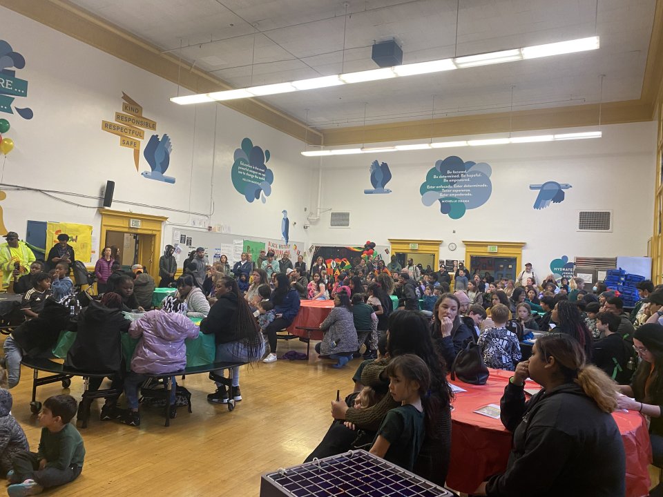 Families gathered in cafeteria at Flynn for Black History Night