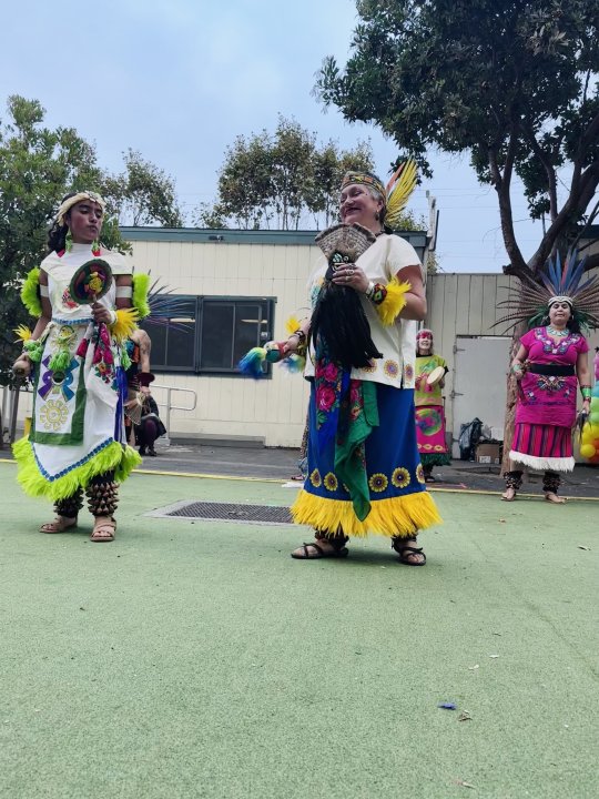 Ms. Meza and her daughter dancing traditional Mexican dance