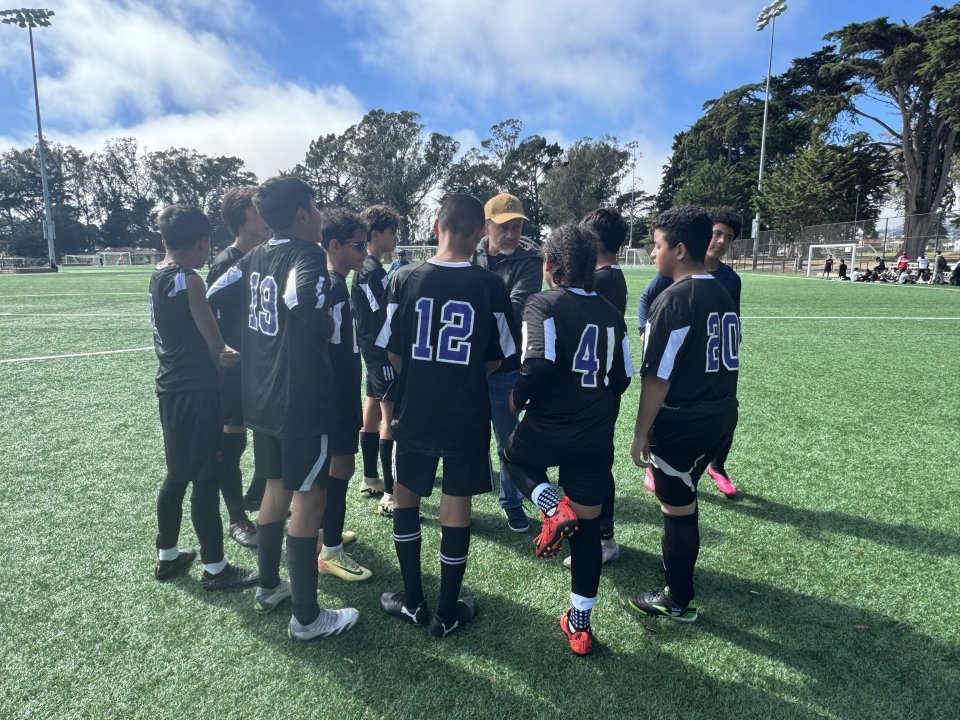 soccer team huddling