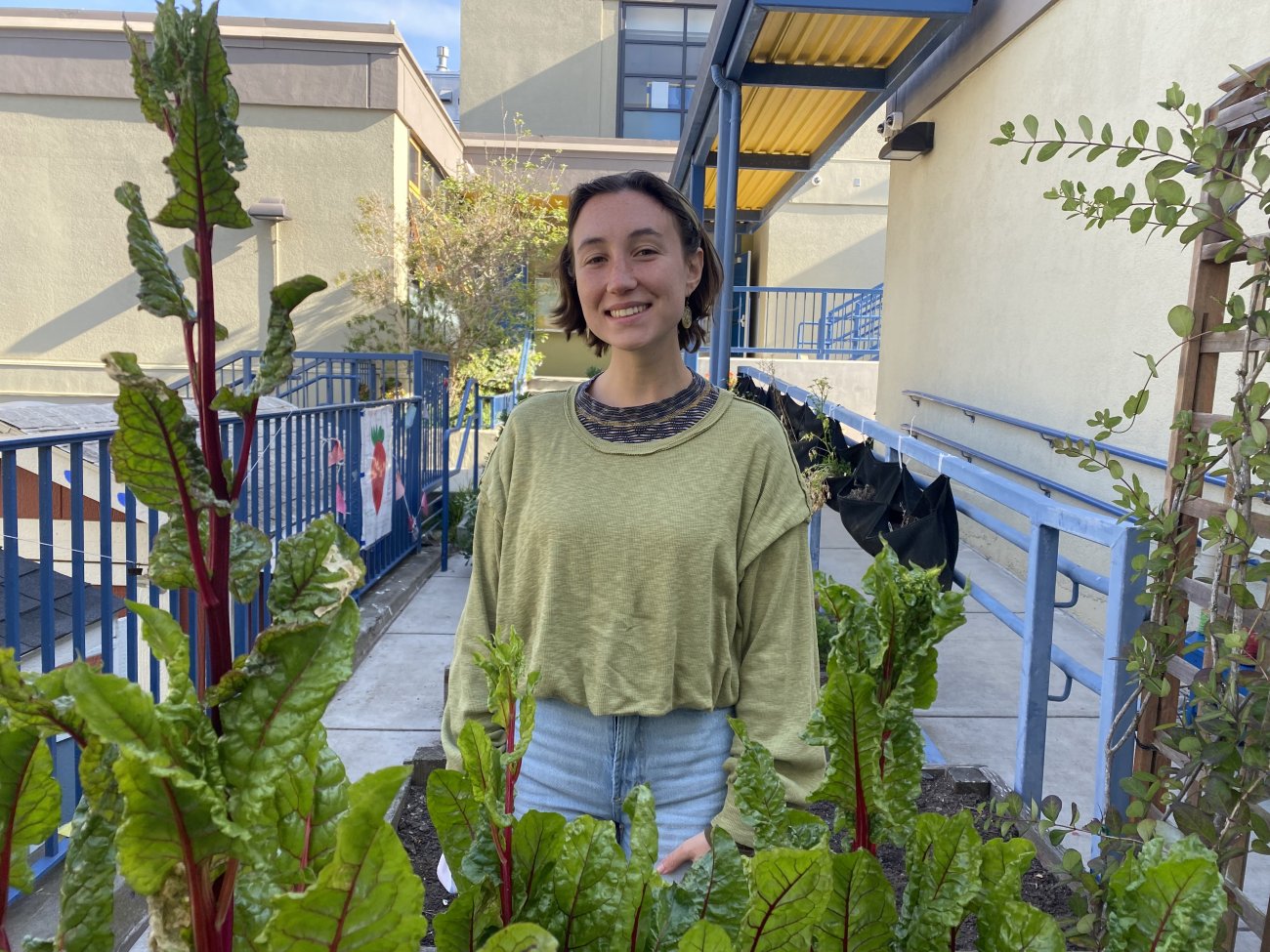 Sarah Bayer, a garden teacher at George Peabody Elementary School, stands in the school garden