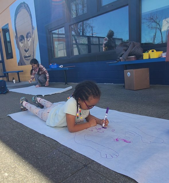 Kindergartener using math to find her height, and color in her shadow!