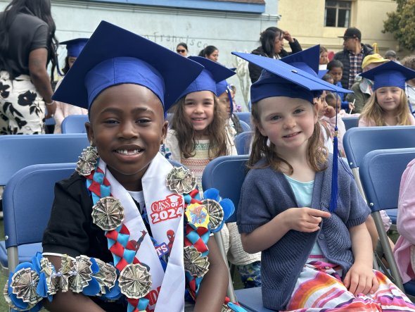 marshall kindergarteners graduating in caps and gowns