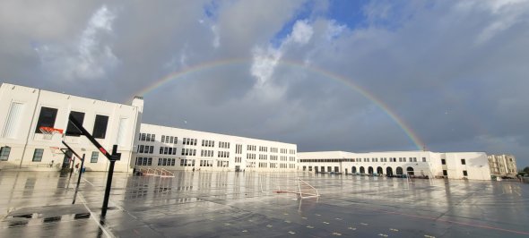 Picture of a rainbow appearing over Marina after a rainy day, taken from the yard