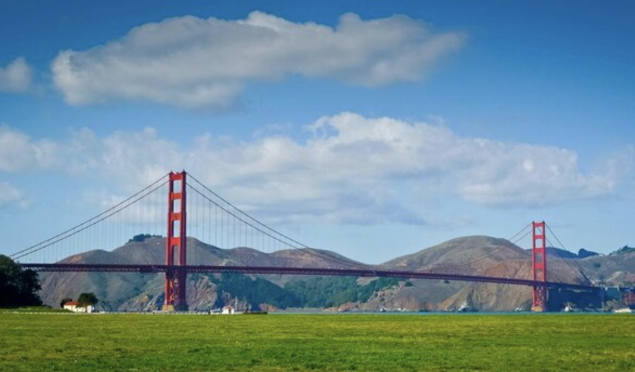 Golden Gate bridge with grassy field in front
